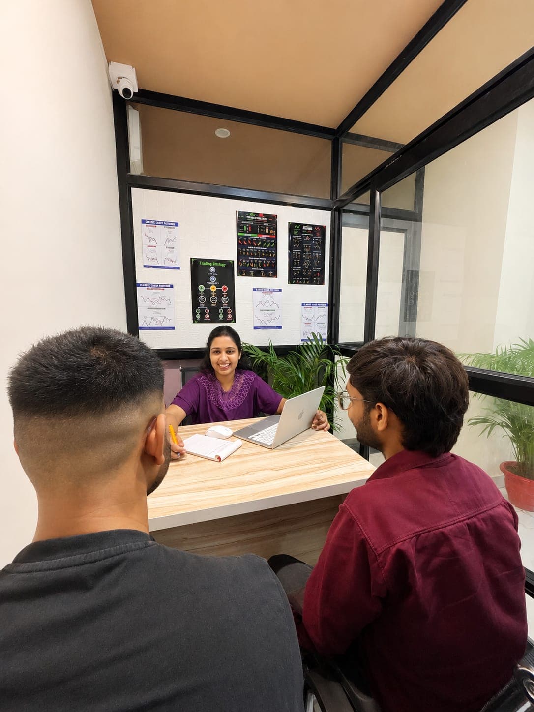 A TradeAura mentor guiding two students through a trading strategy during a one-on-one session